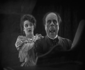 The Phantom's visage is revealed in one of horror cinema's most iconic moments.